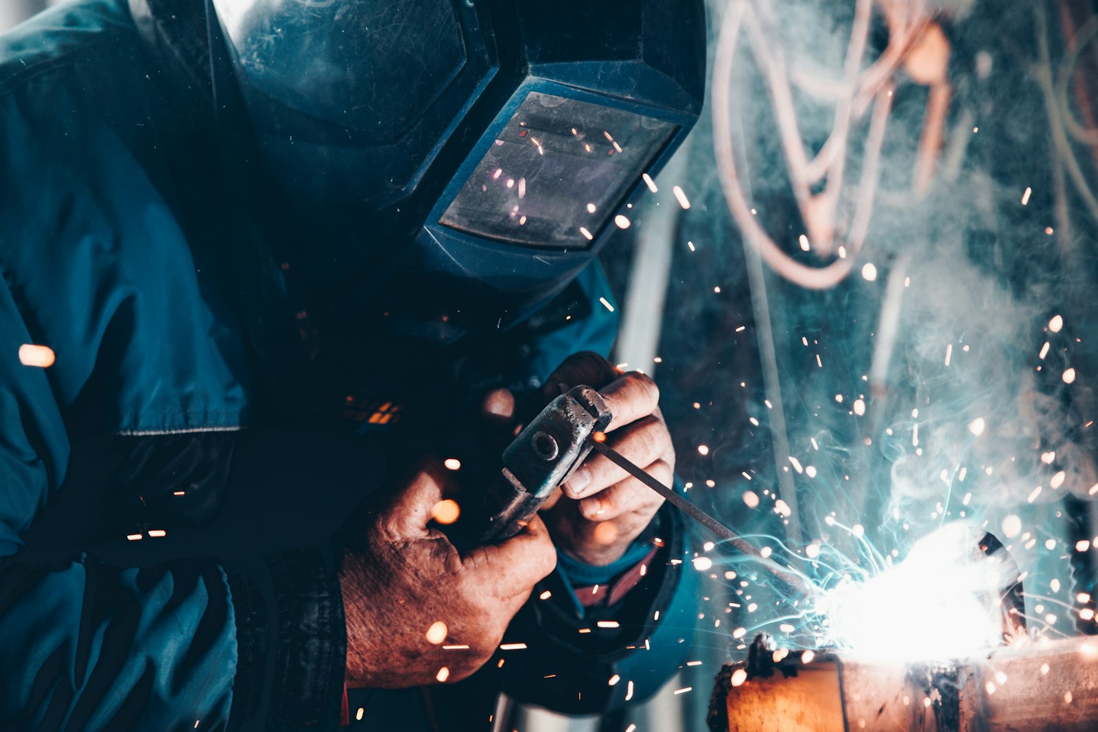 A welder at work in a manufacturing bay.