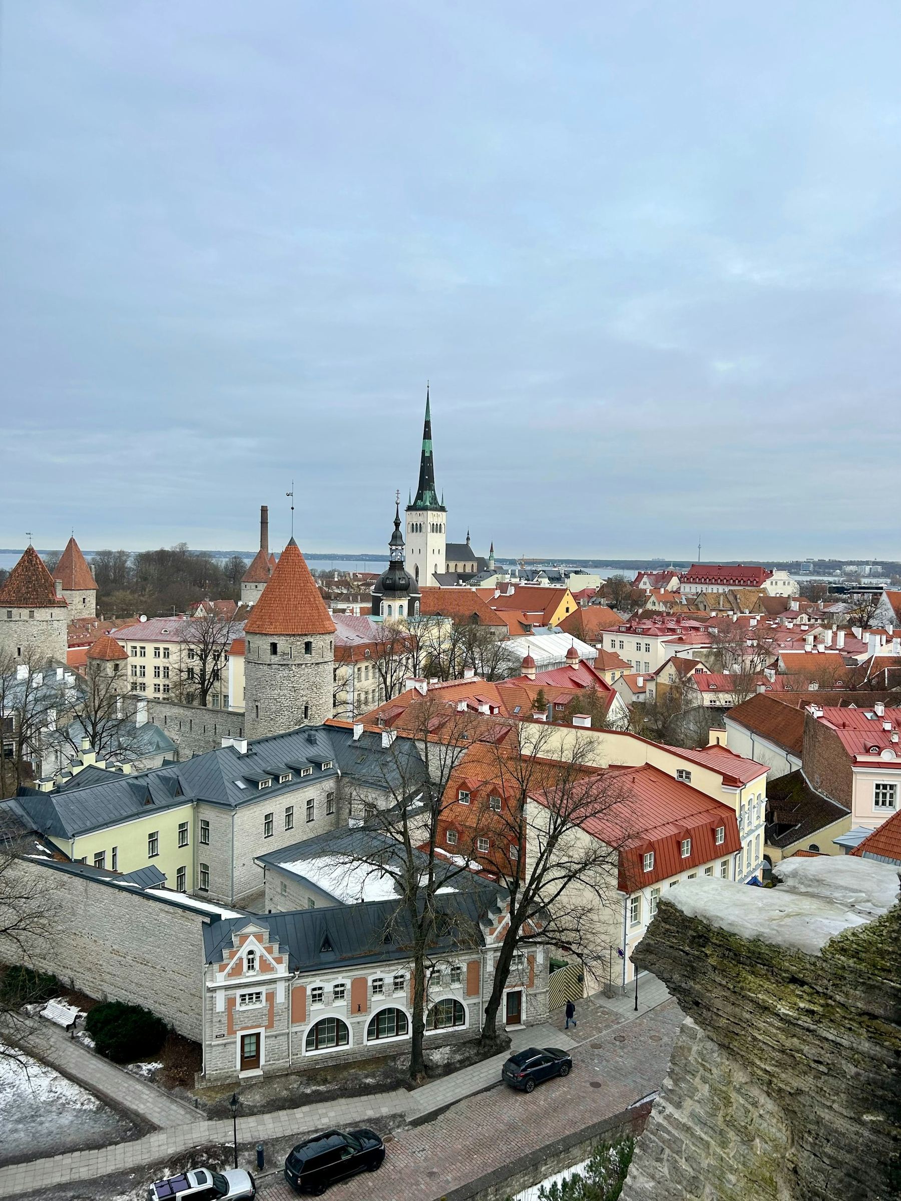 Tallinn Old Town in Estonia, with stone towers, red roofs and the Baltic beyond the city wall.